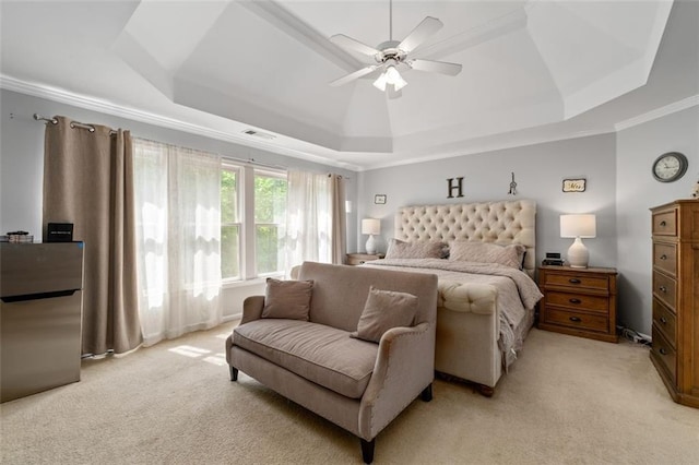 bedroom featuring a tray ceiling, light carpet, ornamental molding, a ceiling fan, and freestanding refrigerator