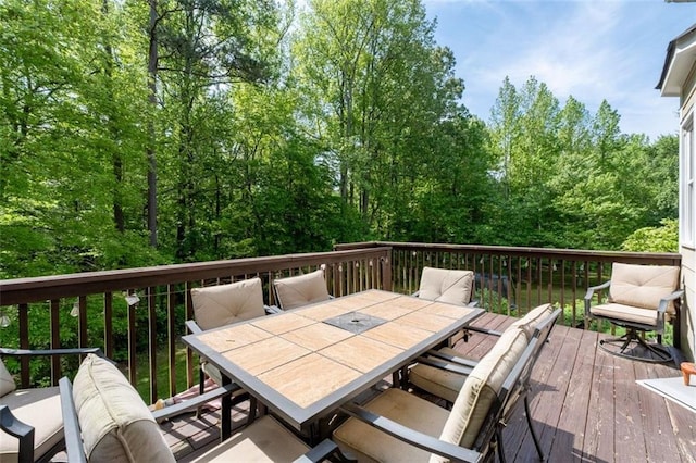 wooden deck featuring outdoor dining space