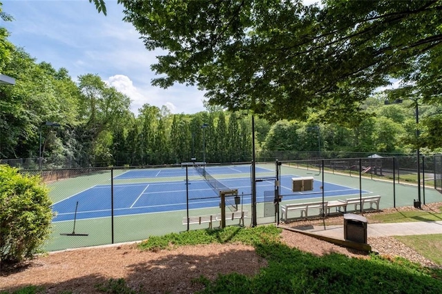 view of tennis court featuring fence