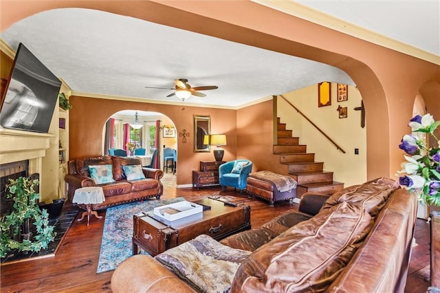 150 Wilbanks St, Buford, GA 30518 - living room featuring arched walkways, a ceiling fan, wood finished floors, stairway, and a fireplace