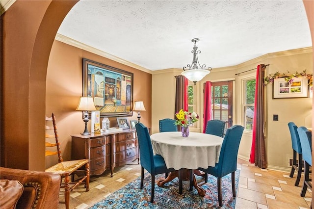 150 Wilbanks St, Buford, GA 30518 - dining room with stone tile floors, arched walkways, ornamental molding, baseboards, and a textured ceiling