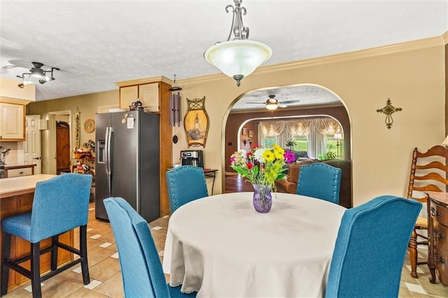 150 Wilbanks St, Buford, GA 30518 - dining area with arched walkways, ceiling fan, light tile patterned flooring, and crown molding