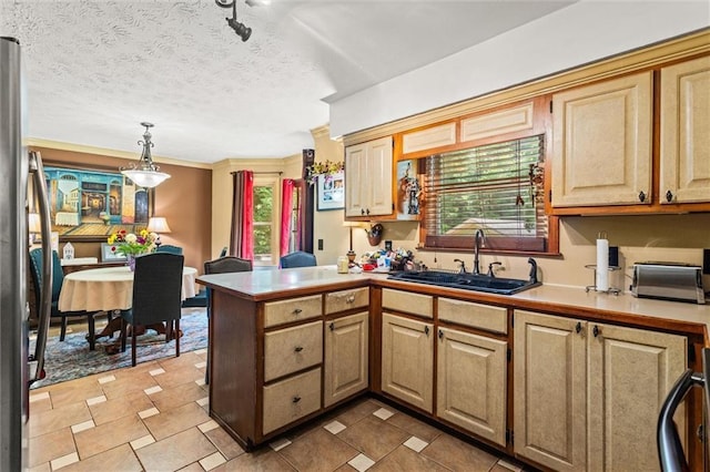 150 Wilbanks St, Buford, GA 30518 - kitchen featuring a sink, a peninsula, pendant lighting, a textured ceiling, and freestanding refrigerator