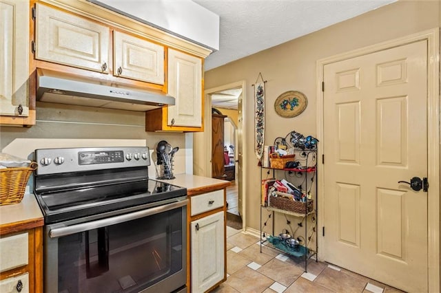 150 Wilbanks St, Buford, GA 30518 - kitchen with electric range, under cabinet range hood, light tile patterned floors, and light countertops