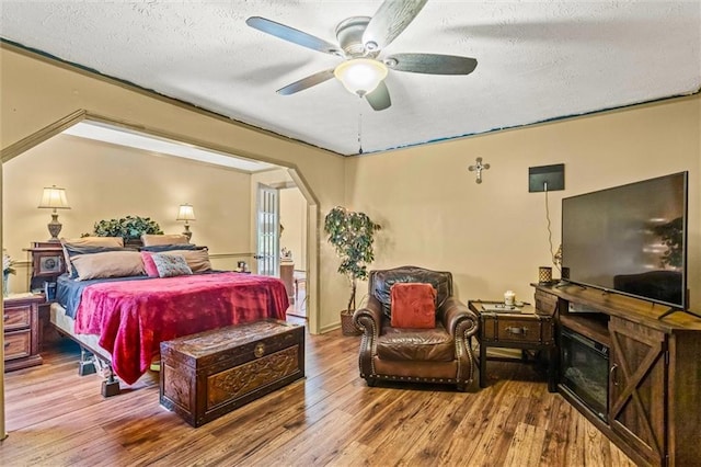 150 Wilbanks St, Buford, GA 30518 - bedroom featuring hardwood / wood-style floors, a textured ceiling, arched walkways, and ceiling fan