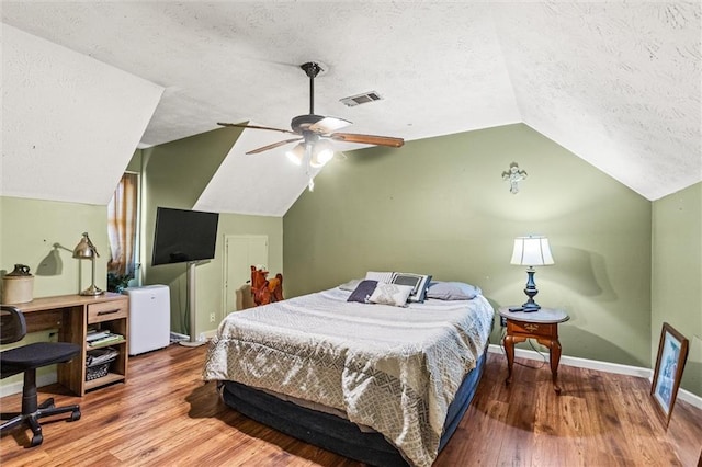 150 Wilbanks St, Buford, GA 30518 - bedroom with a textured ceiling, lofted ceiling, baseboards, wood finished floors, and ceiling fan