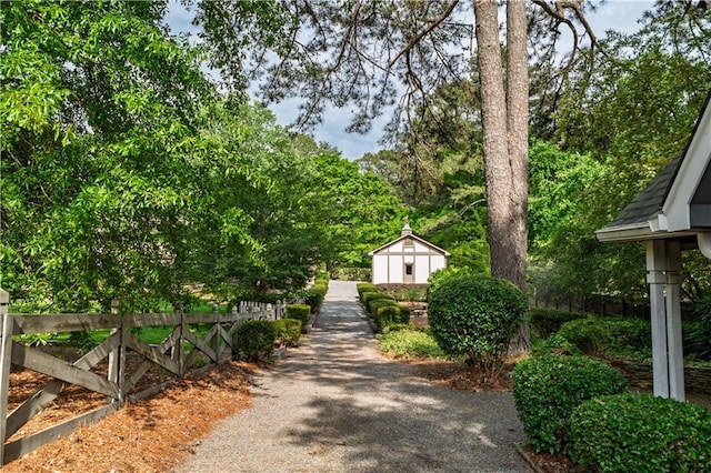 view of community featuring an outbuilding and fence