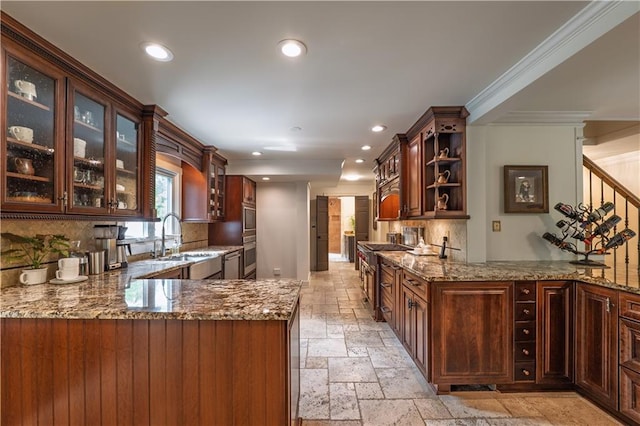 kitchen with a sink, recessed lighting, a peninsula, decorative backsplash, and stone tile flooring