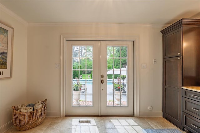 entryway with crown molding, baseboards, and french doors