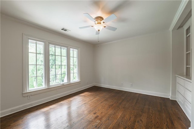 empty room featuring ceiling fan, dark wood-style flooring, visible vents, crown molding, and baseboards