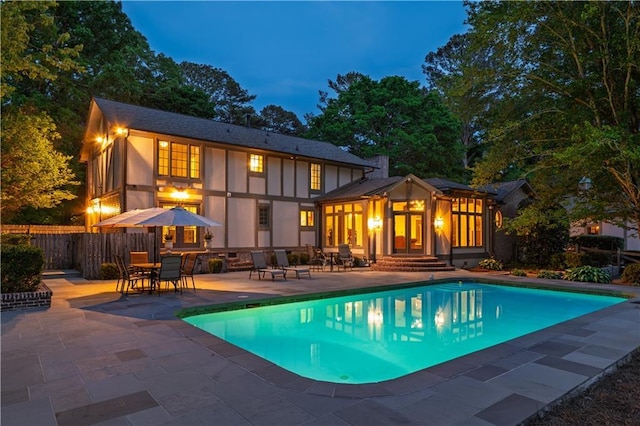 view of swimming pool featuring a fenced in pool, fence, a patio, and outdoor dining space