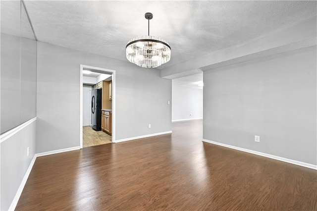 interior space with baseboards, a notable chandelier, and light wood-type flooring