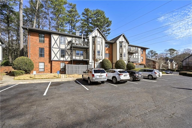 view of building exterior with uncovered parking