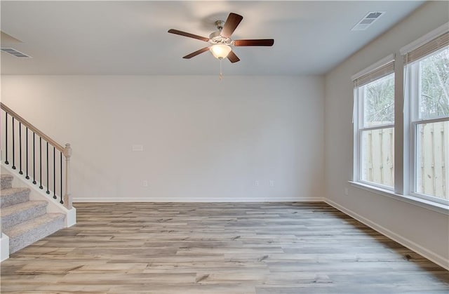 unfurnished room with light hardwood / wood-style flooring and ceiling fan