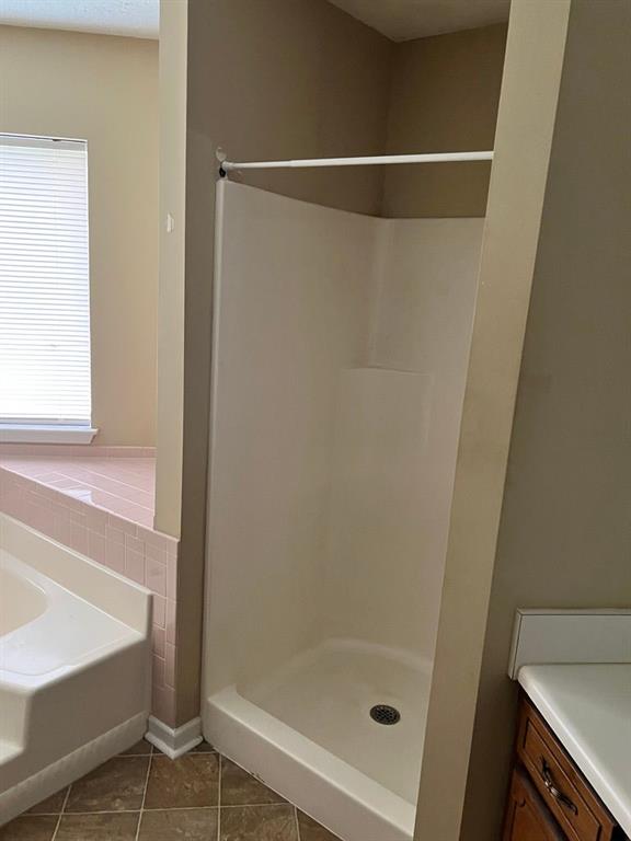 432 Manor Estates Dr, Stockbridge, GA 30281 - full bath featuring tile patterned flooring, a shower stall, a bath, and vanity