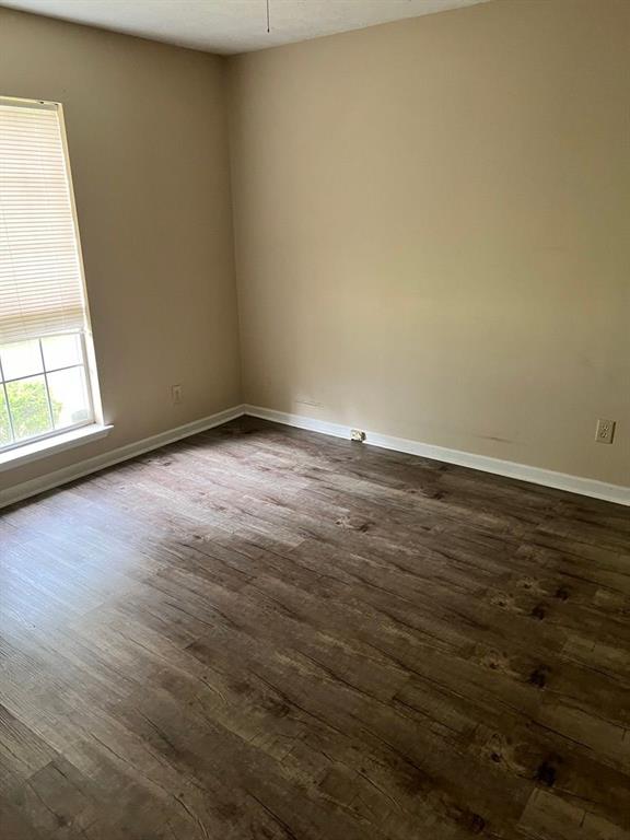 432 Manor Estates Dr, Stockbridge, GA 30281 - empty room featuring dark wood-style flooring and baseboards