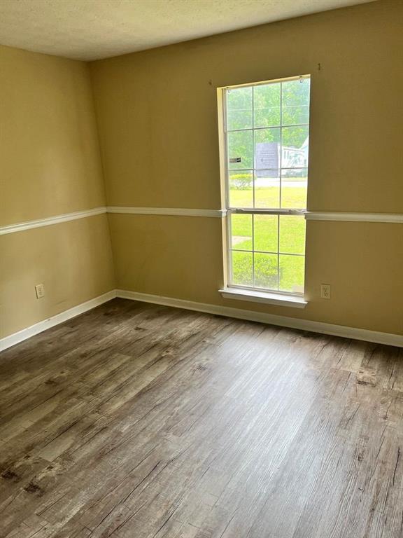 432 Manor Estates Dr, Stockbridge, GA 30281 - spare room with wood finished floors, healthy amount of natural light, baseboards, and a textured ceiling