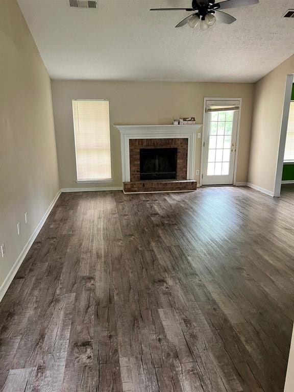 432 Manor Estates Dr, Stockbridge, GA 30281 - unfurnished living room featuring a ceiling fan, dark wood-style floors, a fireplace, and baseboards