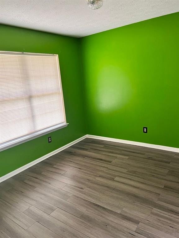432 Manor Estates Dr, Stockbridge, GA 30281 - unfurnished room featuring dark wood finished floors, a textured ceiling, and baseboards