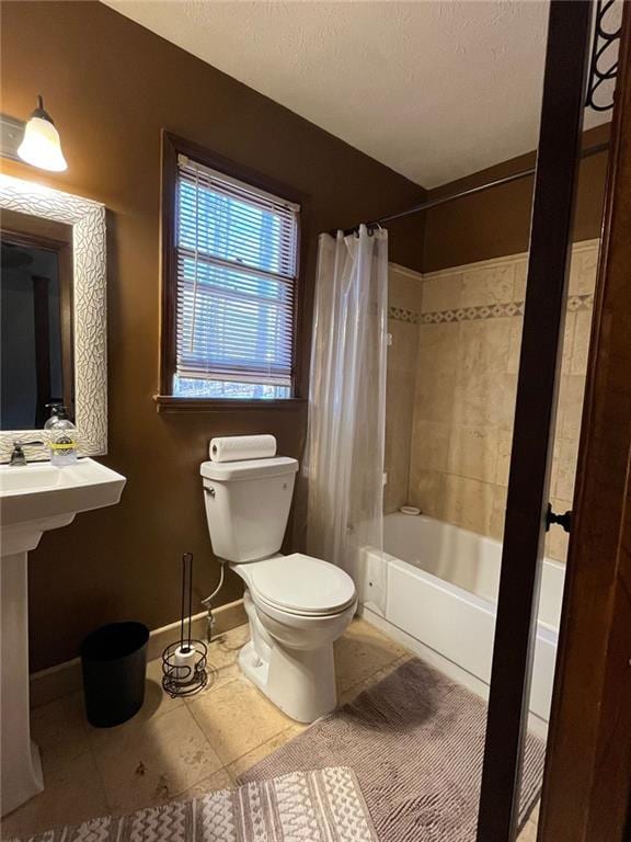 bathroom featuring shower / bathtub combination with curtain and toilet