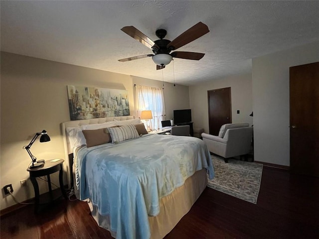 bedroom with dark hardwood / wood-style flooring, a textured ceiling, and ceiling fan