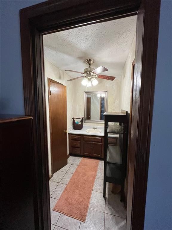 bathroom featuring vanity, ceiling fan, tile patterned floors, and a textured ceiling