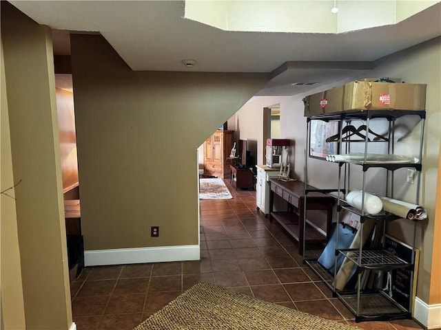 interior space with dark tile patterned flooring