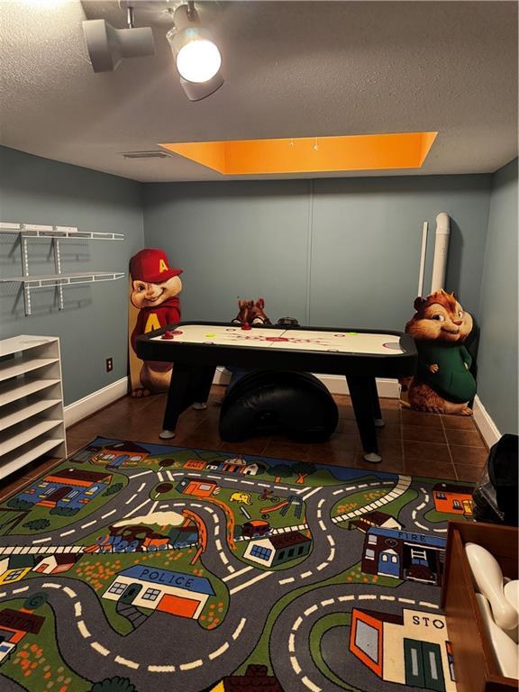 playroom with a textured ceiling