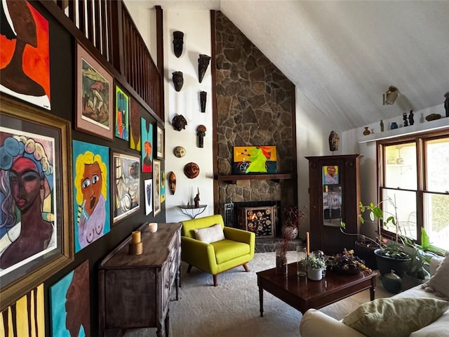 living area featuring lofted ceiling, a stone fireplace, and carpet flooring