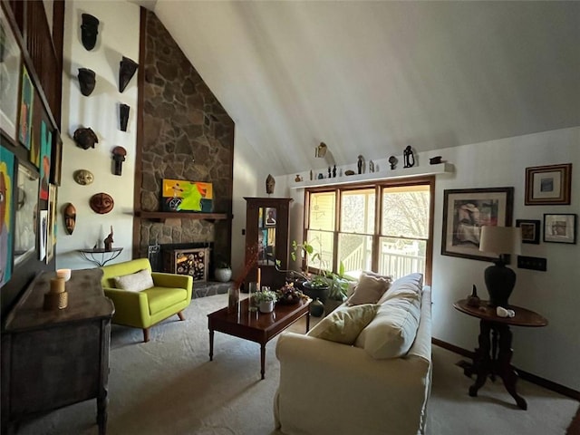 sitting room with lofted ceiling, a stone fireplace, and light colored carpet