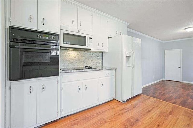 kitchen featuring light wood-style flooring, ornamental molding, black appliances, white cabinets, and tasteful backsplash