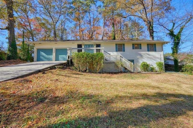 single story home with driveway, a front lawn, and an attached garage