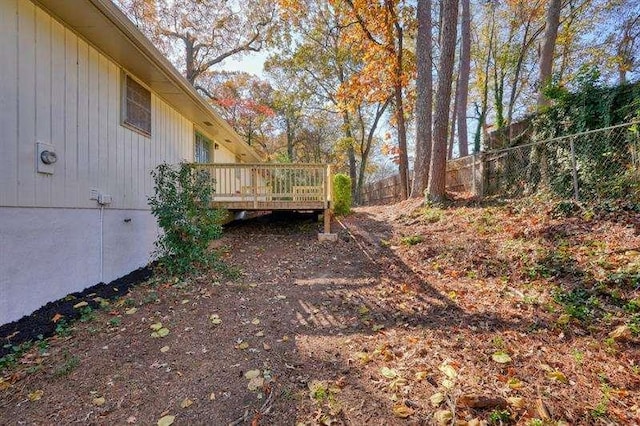 view of yard featuring a deck and fence