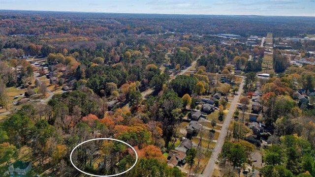 drone / aerial view featuring a view of trees