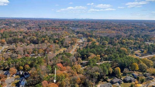 drone / aerial view featuring a wooded view