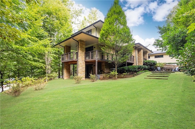 back of house with a deck and a lawn