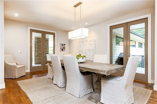 dining room featuring hardwood / wood-style floors and french doors