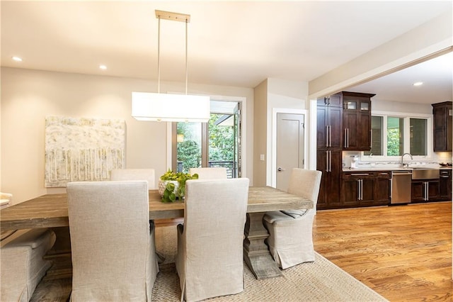 dining room featuring sink and light wood-type flooring