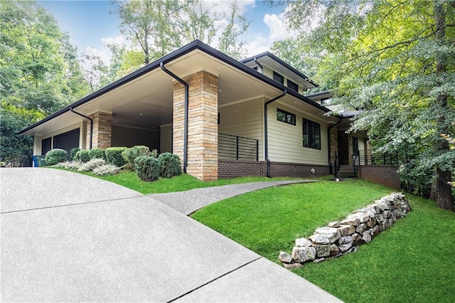 view of side of property featuring a garage and a yard