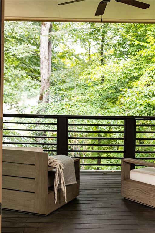 wooden deck featuring ceiling fan