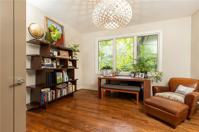 living area featuring dark wood-type flooring and a chandelier