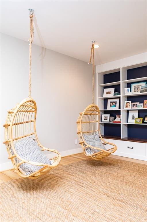 living area featuring hardwood / wood-style flooring and built in features