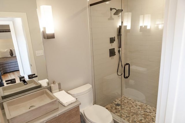 bathroom with vanity, toilet, and walk in shower