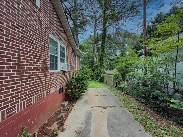646 Quillian Ave, Decatur, GA 30032 - view of property exterior featuring brick siding, fence, and a patio area