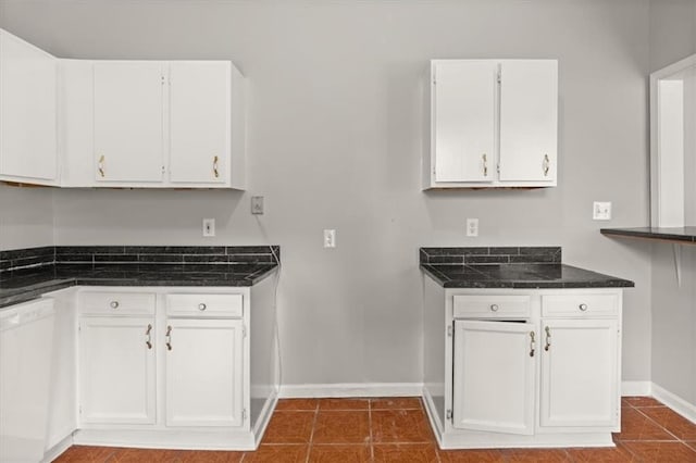 kitchen featuring tile patterned flooring, white cabinets, and white dishwasher