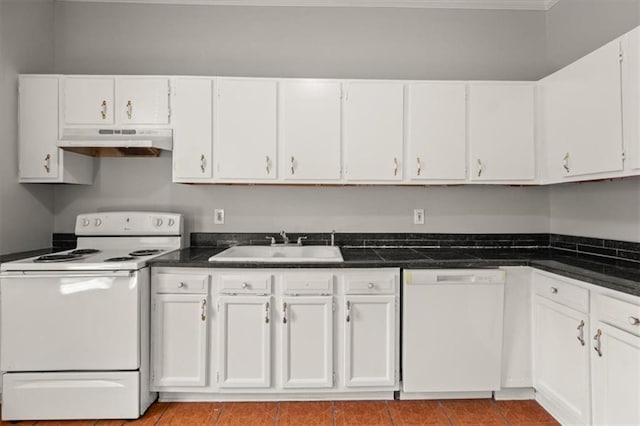 kitchen with white cabinets, white appliances, light tile patterned floors, and sink