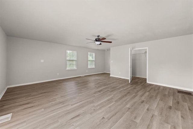 empty room featuring ceiling fan and light wood-type flooring