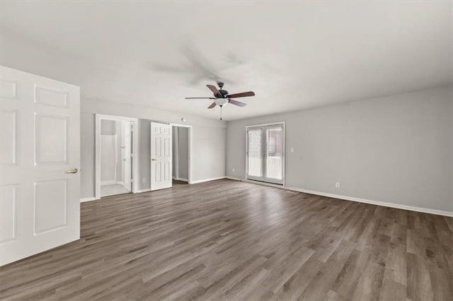 empty room with ceiling fan and dark hardwood / wood-style flooring