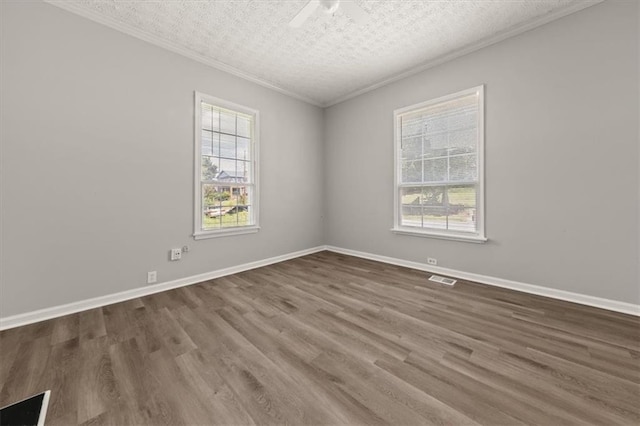 unfurnished room with ceiling fan, a textured ceiling, dark wood-type flooring, and crown molding