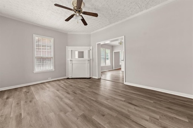 spare room with a textured ceiling, dark hardwood / wood-style flooring, and plenty of natural light